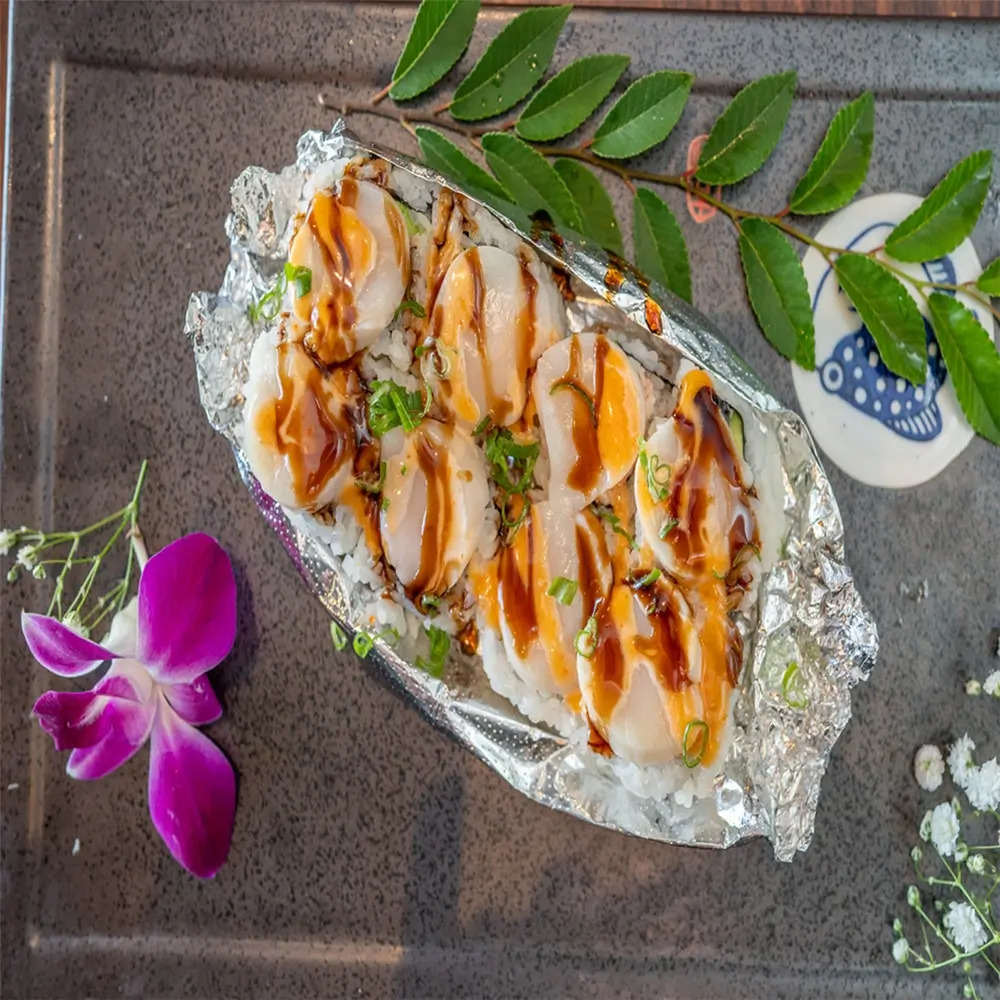 Scallop Sushi consists of sushi topped with fresh scallop slices at MJ Sushi - Palo Alto, a Japanese restaurant in CA