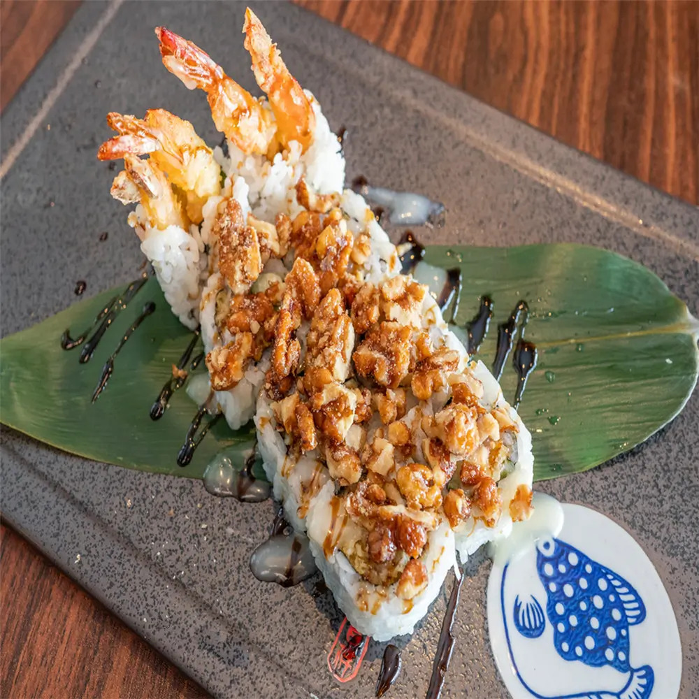 Shrimp Peanut Crispy Sushi consists of sushi rolls with shrimp, topped with chopped peanuts and crispy bits
