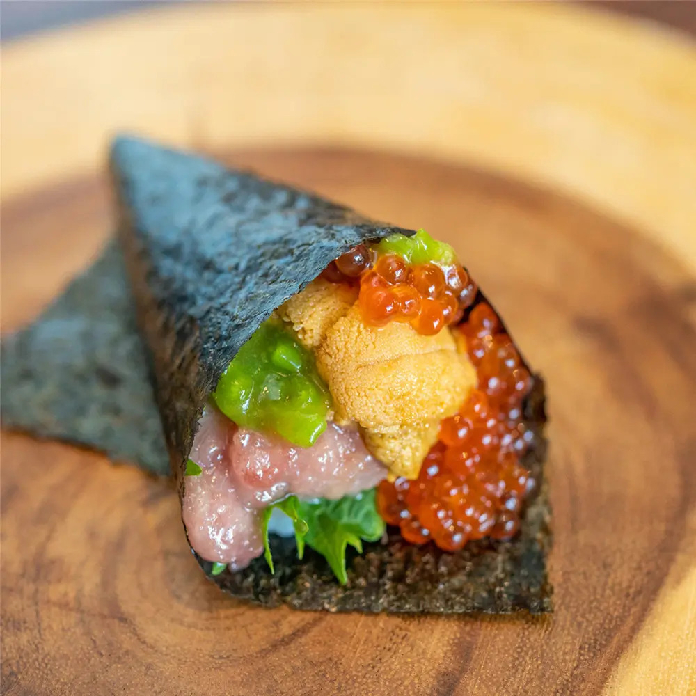 Sushi Temaki is a cone - shaped sushi roll filled with ingredients like fish roe, minced fish, and vegetables